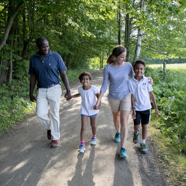 Family walking on the trails in the woods